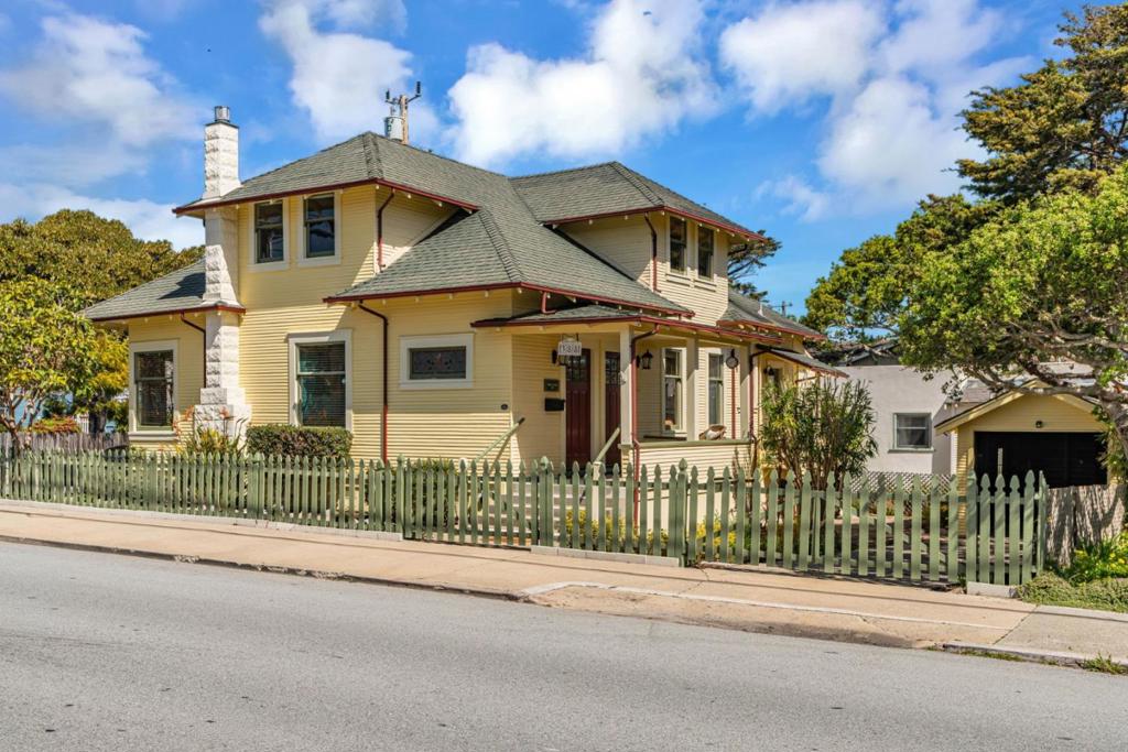 This approximately 1,940 square foot, 4 bedroom, 3 bathroom home features the flexibility to use the homes as a single family home or a duplex. Located just one block from the Bay and five blocks from downtown Pacific Grove, this charming Victorian-era home was built in 1910 and offers a formal dining room and an updated kitchen with stainless steel appliances and new flooring. The spacious, bright, and sunny rooms showcase the grand architectural details of the era, including a large living room with a fireplace and bay windows and high ceilings and updated kitchen. The home provides views of the Bay, adding to its cheerful and inviting atmosphere. Ideal for a variety of living situations, this property offers a unique opportunity to take advantage of its versatile layout and desirable location.