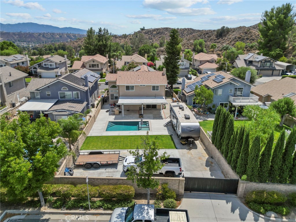 INCREDIBLE PROPERTY W/ SERIOUS RV, TOY, AND BOAT STORAGE, AND POOL/SPA ON A CUL DE SAC, IN HIGHLY DESIRED NORTH SAUGUS / COPPERHILL... THIS HOME IS REALLY A MUST SEE! This home is one only 3 lots in the entire community that offer front AND rear access to the lot. Wood floors wrap around the entire downstairs and into the kitchen. The newly remodeled kitchen boasts all new cabinets featuring soft close technology, custom quartz counters w/ waterfall, and designer built in stainless steel appliances including built in fridge. Just off the kitchen is a sunken dining room offering a custom wine & coffee wet bar w/ quartz counters and waterfall, and built in temperature controlled wine storage. The home features an individual laundry room as well. All 4 bedrooms are upstairs, and the master suite has been completely remodeled. The master suite offers a HUGE walk in closet, and the ensuite features all new cabinetry, quartz counters, a huge walk in shower w/ rain shower head, and custom tile, and glass. The entire home offers dual pane windows, and plantation shutters, accented downstairs by vaulted, cathedral ceilings. The front of the house sits on a quiet cul de sac, and the rear of the house sits on ANOTHER cul de sac. Electric gates allow for rear access to park all of your toys! This well thought out property offers FULL RV/trailer hook ups w/ 50 amp service, RV dump, and room for 4-5 RVs! This magnificent property also offers a newer Pebble Tech pool, and spa, w/ Baja Shelf, and outdoor BBQ, kitchen combo. This home is located in a prime location close to award winning schools, fine dining, shopping, parks, and just a block away from famous 'Candycane Lane" Christmas show on Wakefield Court! With NO HOAs, and NO MELLO ROOS this beauty won't last long! This home can be shown 7 days a week, so call today for your private showing!