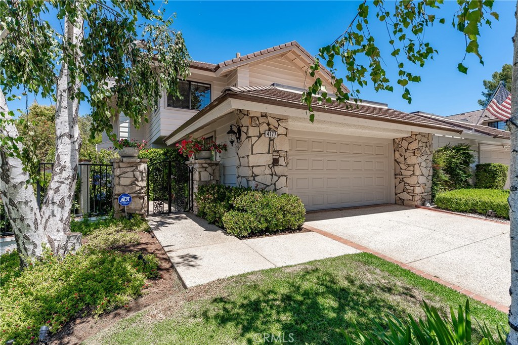 Immaculate highly upgraded North Ranch townhome that truly feels like a single family home with extremely rare private swimming pool & spa, located in the highly desirable Fairgreen Townhomes, a quiet cul-de-sac community that sits on the 5th Fairway of the North Ranch Golf Course. The beautifully manicured front yard features wide driveway that leads to the 2-car finished garage with direct access. A gated front entry opens to a meandering pathway flanked by mature landscaping and a trickling water fountain. Inside you find a spacious entry foyer with convenient guest powder bathroom with new vanity that opens to an expansive sunlit living room boasting two-story soaring ceiling, mantled fireplace, and wall-to-wall windows with plantation shutters. The formal dining room has direct kitchen access and a remodeled wet bar with wine fridge, stone counters, and built-in soft close cabinetry. The separate living room has a stacked stone fireplace and large glass slider that opens to the yard ideal for indoor/outdoor flow. The upgraded kitchen has stainless appliances, double ovens, 5-burner stove with pot filler, granite countertops, pantry space with pullout drawers, and separate cozy breakfast nook overlooking the yard. Upstairs you will find a sprawling landing with abundant built-in storage and new stone counter. The luxurious primary suite features vaulted ceiling, new wide plank wood floors, mantled fireplace, cedar lined walk-in closet with second wardrobe closet, and private en-suite remodeled bathroom with built-in vanity, dual sinks, soaking tub, separate walk-in shower with multiple body sprays, and large picture windows. Two additional well appointed bedrooms are located on their own wing, each featuring new wide plank wood floors, custom closets, and they share a remodeled hall bathroom with new vanity and walk-in shower with skylight. An indoor laundry area has built-in storage cabinets and can fit side-by-side machines plus there is a separate walk-in storage closet/pantry. The entertainer’s backyard boasts swimming pool and spa, oversized covered patio with new ceiling fan and TV perfect for dining alfresco, BBQ center with new stone countertop, and private lush landscaping. Community amenities include a clubhouse, pool, spa, and the community is adjacent to Upper Ranch Park and great dining and shopping!