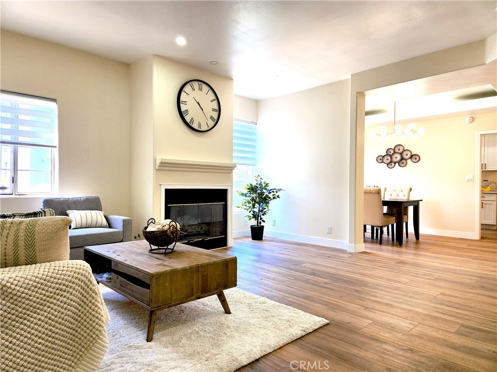 **PRICE REDUCED!!! MOTIVATED SELLER** Welcome to this beautifully updated condo in the heart of Valley Village! Filled with natural light, this two-story home offers a warm and inviting atmosphere. The first floor features a spacious living room with a cozy fireplace, a dining area, a modern kitchen, a stylish wet bar with a wine fridge, and a convenient half bath. The floors are upgraded with luxury vinyl throughout, and the kitchen boasts brand-new American shaker-style cabinets, quartz countertops, and new stainless steel appliances. You'll also find a practical storage space under the stairs. Upstairs, there are two ensuite bedrooms with high ceilings and ceiling fans, creating a bright and airy feel. Both rooms offer generous closet space with mirrored closet doors. The primary bathroom features double sinks, a freestanding soaking tub, and a separate shower. The second full bathroom also has double sinks and a bathtub. All bathrooms have tile flooring and new toilets for a fresh, clean finish. Every window is fitted with elegant zebra-style blinds, and the laundry room is conveniently located on the second floor. There's also a charming balcony upstairs, along with an extra storage closet. The unit is equipped with central A/C and heating, and the community offers a gym for residents. You'll enjoy easy access to nearby shops and freeways, making daily life even more convenient. Two parking spaces are included, along with a personal storage area in the garage. This fully renovated condo is move-in ready and waiting for its new owner!