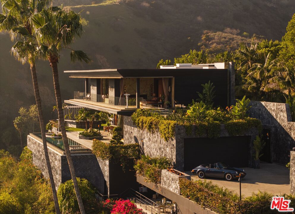 Presenting the White Lotus House, an architectural modern paradise meticulously constructed over seven years, utilizing the finest materials and millions just in stonework alone. The only budget was there was no budget; everything had to be the best. Combining modern new construction with the retro charm of the golden age, embracing the rich history of Hollywood and the lifestyles of its icons. Designed with Asian influences to make you feel like you're living in paradise. Equipped with the latest amenities, and very own private speak easy night club. Situated on a promontory lot with unobstructed front row views of the city from downtown out to the Pacific Ocean. This is a one-of-a-kind trophy estate you won't find anywhere else in the world or see replicated due to soaring construction costs, architectural design significance and the attention to detail. This unparalleled estate isn't just a home; it's a once-in-a-lifetime experience for you to ink any deal and redefine the art of living.
