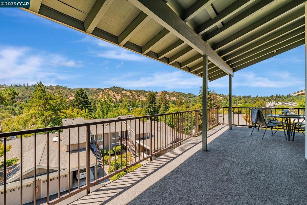 Welcome to this upper-level Cascade model with rare hardwood floors, offering a stunning combination of space, style, and breathtaking views. The rare parquet flooring throughout lends warmth and timeless elegance. The spacious living room boasts vaulted ceilings and large windows that flood the home with natural light, while a wood-burning fireplace creates the perfect setting for cozy evenings. A built-in wine bar and generous entryway closet add both charm and functionality. The remodeled kitchen features newer cabinetry, dark granite countertops, a double stainless steel sink, and a dramatic subway tile backsplash in a mix of grays, blacks, and light tones. The appliances include a stainless steel Frigidaire stove, GE refrigerator with ice maker, and an LG microwave. The open-concept design in the living room connects seamlessly to the dining area, which flows to a large open balcony with spectacular westerly sunset views. The primary suite features a bath with dual sinks, abundant mirrored closet space, and a shower-over-tub bath. The guest bath has a single sink and stall shower. A sliding glass door opens to the large open balcony with sweeping southwest views of a lush mix of deciduous and evergreen trees and rolling hills—a truly tranquil way to begin and end the day!