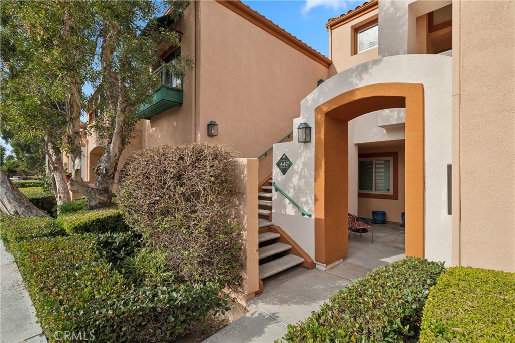 Located in the gated Villa Point community, this upper-level 2-bedroom, 2-bathroom home with a loft combines comfort, functionality, and beautiful golf course views. Filled with natural light, the open living area features new carpet and laminate flooring, a cozy fireplace, and sliding doors that open to a private balcony—perfect for relaxing or entertaining. The kitchen includes tile countertops, an electric cooktop, a mini wine fridge, and a convenient breakfast bar that opens to the living space. The primary suite offers dual closets, dual sinks, and direct balcony access. Upstairs, the loft provides a versatile space for a home office or den, complete with a built-in desk and cabinetry. Additional highlights include in-unit laundry, ample storage, central A/C, and a one-car garage. Residents of Villa Point enjoy resort-style amenities, including pools, spas, and barbecue areas, all just minutes from Fashion Island, Corona del Mar, and Newport’s beautiful beaches.
