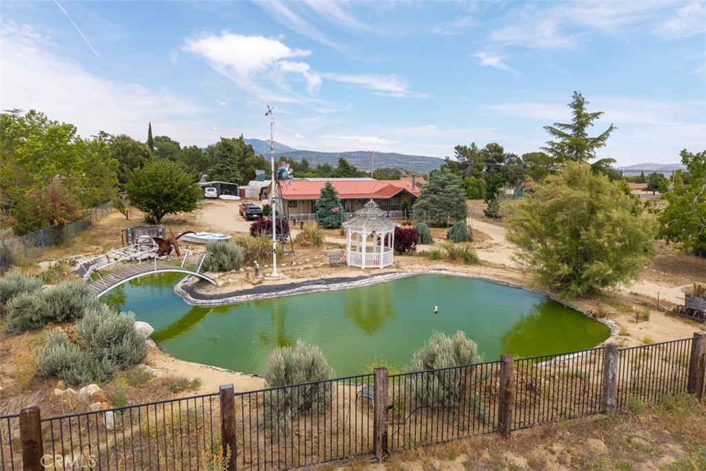 Discover your dream home on this meticulously maintained estate, perfectly positioned just off Highway 371 with convenient paved road access. This stunning property showcases the perfect blend of privacy and accessibility, featuring a completely fenced lot with your very own private pond!
OUTDOOR LIVING AT ITS FINEST: • Serene front yard with professional landscaping • Inviting covered front porch - perfect for your morning coffee • Private pond creating a peaceful atmosphere • Covered back patio ideal for entertaining • Abundant fruit trees • Chicken coop for fresh eggs daily • RV hookups for your recreational vehicles
INTERIOR HIGHLIGHTS: • Spacious 3 bedroom, 2 bath open-concept layout • Bright, airy living room with cozy fireplace • Premium laminate wood flooring • Large windows throughout for abundant natural light • Generous dining area flowing into gourmet kitchen • Kitchen features modern island for extra prep space • Luxurious primary suite with:
Oversized windows
Spa-like bathroom
Dual vanity sinks
Separate shower and soaking tub • Dedicated laundry room with utility sink and storage
EXCEPTIONAL STORAGE & WORKSPACE: • Massive detached 3-car garage with workshop • Two additional metal carports • Ample parking for all your vehicles and toys
PRIME LOCATION: • Just 5 minutes from schools • Central location with easy highway access • Perfect blend of countryside living and modern convenience
Don't miss this rare opportunity to own your own slice of paradise! Driven Real Estate does not guarantee the accuracy of the square footage, lot size, or other information concerning the conditions or features of the property provided by the sellers or obtained from Public Records or other sources. The buyer with their agent(s) is advised to independently verify the accuracy of all information.