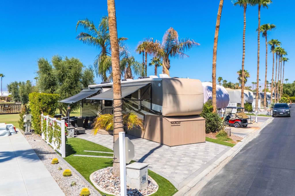 This beautiful golf course lot offers privacy and stunning views in the heart of Outdoor Resorts Palm Springs. Expanded with pavers, the patio side is bordered by fencing and mature hedges, creating a perfect, private space for outdoor relaxation. Enjoy panoramic golf course and mountain views from this prime location. The RV is a pristine 2019 DRV Mobile Suites Santa Fe, offering luxurious living in immaculate condition. Whether you're relaxing on the private patio or enjoying the resort's many amenities, this lot/RV package is move-in ready and ideal for your winter retreat. Ideally situated, this lot is just a short distance from the La Palma Clubhouse, tennis courts, fitness center, pool, and spa, ensuring that top-tier amenities are always within reach. Outdoor Resorts Palm Springs is a Five Star RV Resort Community combining luxury with affordability. It is a guard gated resort that sits on 137 beautifully landscaped acres with 27 holes of executive golf, 10 tennis courts, 13 pickleball courts, 8 swimming pools, a fully equipped fitness center. beauty salon/barber shoo. full-service restaurant. convenience store. 2 club houses, activities, special events and so much more