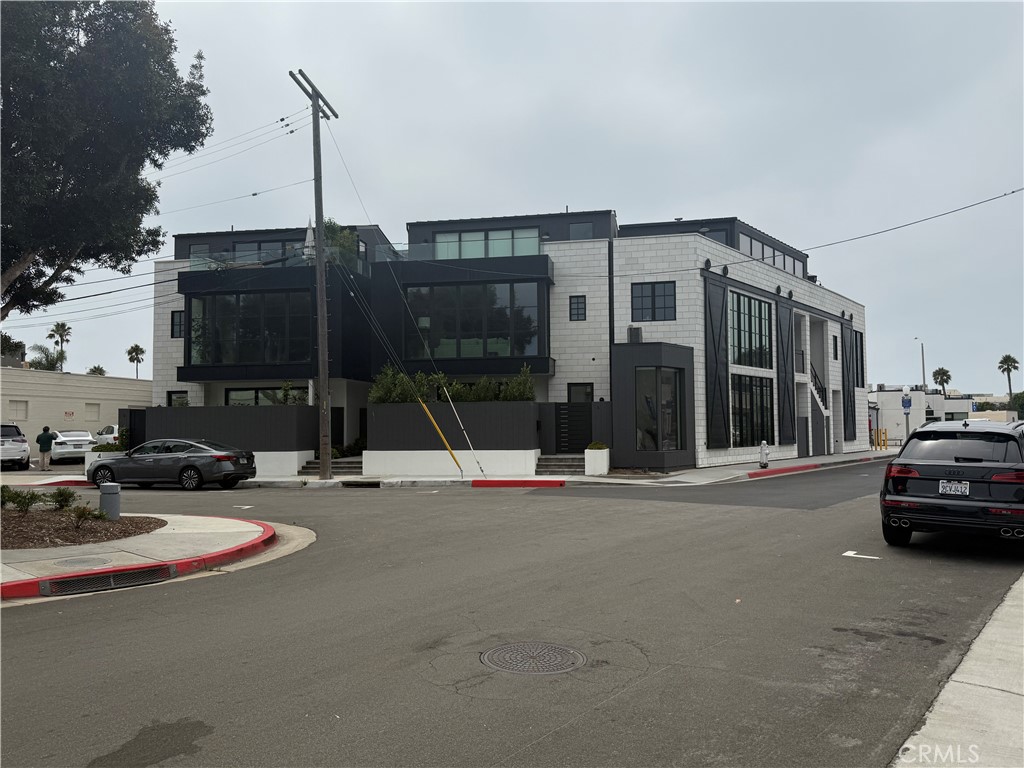 Pictures will be in next week. A stunning modern coastal townhome located in the heart of Newport Beach’s highly sought-after Lido Marina Village. Completed in late 2021, this nearly new residence blends refined elegance with the ease of coastal living.
Spanning 2,509 square feet across three thoughtfully designed levels, the home has been meticulously crafted with high-end finishes and offers the perfect balance of comfort and versatility. Originally designed as three spacious bedrooms, the home currently features two by the owner’s choice—but can easily be converted back to three. It includes three-and-a-half luxurious bathrooms.
The entry level welcomes you with collapsing glass doors that open to a beautifully designed courtyard with pet-friendly, odor-free turf. This level also includes a spacious living area, a large bedroom with an en-suite bath, an additional guest bath, a full laundry room, and direct access to the attached three-car garage. The Second level: The heart of the home is an open-concept living space anchored by a showstopping chef’s kitchen with top-of-the-line appliances, a gorgeous natural stone island with seating, a butler’s pantry, a custom wine cellar with built-in refrigerator, and an inviting dining area. The living room offers warmth with a fireplace, built-in bar, and access to a striking powder room. A “secret room” adds a touch of intrigue and uniqueness that’s must-see. The Third level: The primary suite is a private retreat of modern elegance, complete with sliding glass doors that open to a private balcony. The suite features a wet bar, spa-inspired bathroom wrapped in travertine marble slab, and a custom walk-in closet with abundant tailored storage. European oak floors run throughout, and a private elevator connects all three levels. Every space is enhanced with curated designer finishes.
Enjoy the very best of Newport Beach just moments away—stroll from the marina to the ocean, and savor premier coastal living with fine and casual waterfront dining, specialty coffee shops, fitness studios, and boutique shopping right at your doorstep.
Coastal living at its finest.