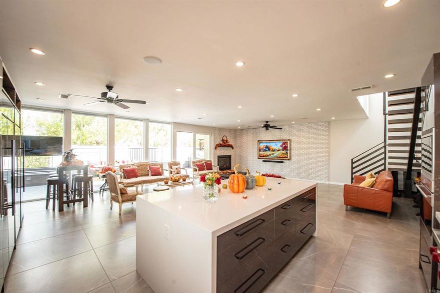 If you are looking for a unique home with high-end materials, this property is for you! Offering approx. 3,200 sq. ft. of living space, fully rebuilt and expanded in 2019 with an 1,800 sq. ft. permitted addition. This home feels like new construction! Features include 5 spacious bedrooms many with en suite baths, a first-floor primary suite with walk-in closet, fireplace, and spa-style bathroom. Plus, a gourmet kitchen with oversized island, imported Spain stone (2023), Sub-Zero & Wolf appliances, and bar area. The living room showcases floor-to-ceiling windows, dramatic fireplace, built-in home theater, and ceiling sound system. Additional highlights: large loft, fully tiled bathrooms, new HVAC (2019), 48 leased solar panels ($229/mo), whole-house water filtration (2022), new roof (2019), and a converted garage guest suite. The private backyard offers premium tile and outdoor fireplace.