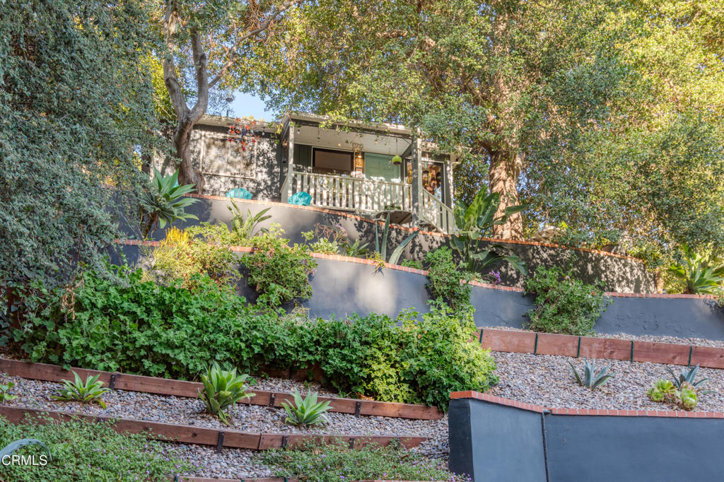 Tucked away in the serene San Rafael Hills of Southwest Pasadena, this enchanting 2-bedroom, 1-bathroom home offers a true escape into nature, while still being just minutes from the vibrant heart of the city. Perched like a treehouse, the property is enveloped by lush greenery and towering old-growth trees, creating an incredibly peaceful, private atmosphere.Entering into the home, the florplan is an open concept creating a large combined space for the living room and kitchen areas. The kitchen has been thoughtfully upgraded with high-end Thermador stainless steel appliances, white subway tile, striking black hardware, a large island and pristine white stone countertops, creating a space that's both functional and visually stunning.The remodeled bathroom features a handsome marbled tile floor, a black lacquer vanity, and a frameless glass shower -- blending modern sophistication with timeless design. Sliding glass doors lead to the private terraced backyard. The large patio area is ideal for entertaining, offering a perfect spot for dining, relaxing, or simply enjoying the tranquil surroundings.This property is located on one of Pasadena's 'Secret Stairs' corridors, the hidden staircases that lace the hillsides of certain L.A. neighborhoods which form a delightful network of urban walking 'trails' that are historical reminders of a time when this was not a city of cars. This home's unique combination of privacy and nature, paired with its convenient location, makes it a rare gem. Experience the best of both worlds: your peaceful, tree-filled retreat in the heart of Southwest Pasadena.Newer dual pane windows and leased solar system with back-up battery.