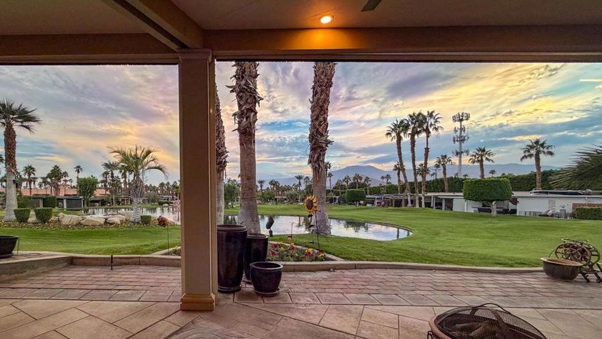 This rare and highly sought-after lot on 'The Hill' offers an elevated vantage point with breathtaking panoramic views of majestic mountains, serene ponds, cascading waterfalls, elegant fountains, and illuminated bridge, all set against the backdrop of a picturesque sunset. Designed for the discerning Class-A motorcoach owner, this lot blends luxury, privacy, and functionality, creating the perfect desert retreat. The insulated roof pergola, enhanced with exterior sconce lighting, provides a comfortable and stylish outdoor living space, while the southern exposure maximizes natural light without overwhelming heat.Enjoy outdoor entertaining with a small kitchen featuring a sink, hot water, and fridge, along with extended pavers, beautifully integrated landscaping, and a privacy wall for added seclusion. The electric and manual screens provide comfort, letting you adjust for sun, shade, or a gentle breeze. The carved concrete RV pad, adorned with an intricate artwork medallion, adds a touch of elegance, while the attached storage cabinet and extra deck boxes provide ample space for your essentials. Mid-lot hookups ensure effortless connectivity, and with room to relax, entertain, and take in the unparalleled scenery. Don't miss out on this exclusive opportunity.‍Outdoor Resort Indio is a Class Only RV resort.