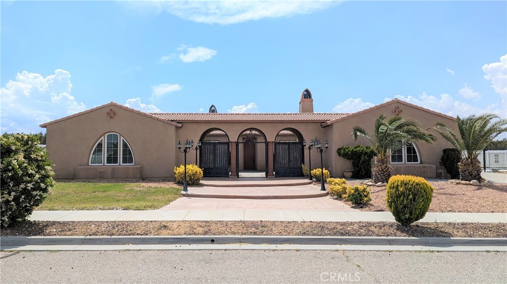 Walk through the enticing front yard and mediterranean-style arched entrance into the calming courtyard. Continue into this beautiful, move-in ready home that awaits you in a quiet corner of Hesperia! A Single-Level Home with 5 Beds, 4-1/2 Baths and a well-designed interior; great for those who want to live in the High Desert! The next-gen design features flexible living spaces, perfect for you or for renting out!
A spacious kitchen with an island and walk-in pantry, a living room with a fireplace, and a primary suite with walk-in closet, bathtub and separate shower. A bonus room you can use as an office, a play room, or a music room. From the courtyard, with its outdoor fireplace and sitting area, enter the guest quarters, which include a bathroom and a kitchenette. Across from the guest quarters, enter the spacious 3-car garage. Walk through the garage onto the large, wide driveway, which provides plenty of space for an RV or boat. The attractive front and back yards both require low maintenance, with a beautiful fountain in the back.
The neighborhood is on the edge of the city and is tranquil. And there is NO HOA TO PAY! Close to the future Brightline West High-Speed Train Station which will serve Hesperia and take you to Las Vegas! Just a few minutes to the 15 Freeway and local schools. Conveniently located close to many shopping and dining opportunities, including The Mall of Victor Valley, Walmart, Target, Ross, Stater Brothers and numerous restaurants.