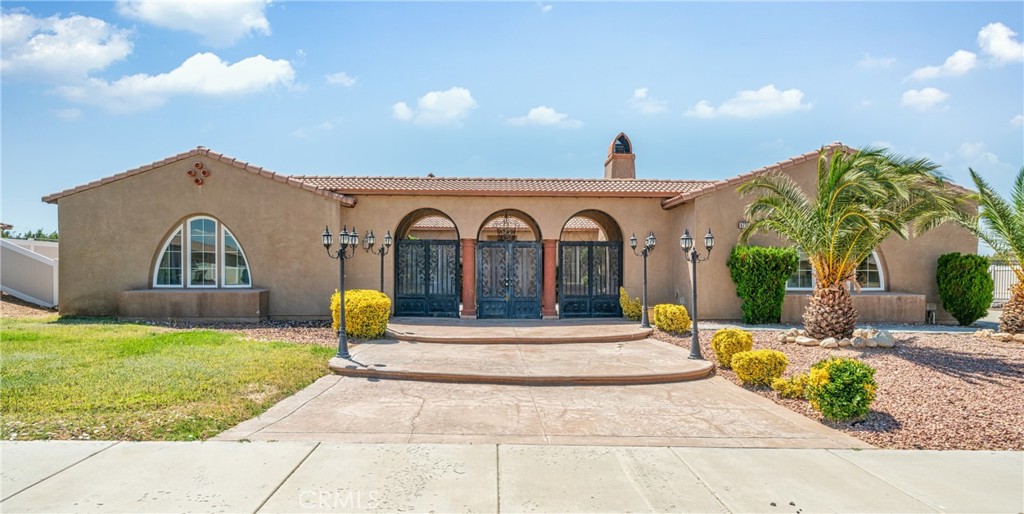 Walk through the enticing front yard and mediterranean-style arched entrance into the calming courtyard. Continue into this beautiful, move-in ready home that awaits you in a quiet corner of Hesperia! A Single-Level Home with 5 Beds, 4-1/2 Baths and a well-designed interior; great for those who want to live in the High Desert! The next-gen design features flexible living spaces, perfect for you or for renting out!
A spacious kitchen with an island and walk-in pantry, a living room with a fireplace, and a primary suite with walk-in closet, bathtub and separate shower. A bonus room you can use as an office, a play room, or a music room. From the courtyard, with its outdoor fireplace and sitting area, enter the guest quarters, which include a bathroom and a kitchenette. Across from the guest quarters, enter the spacious 3-car garage. Walk through the garage onto the large, wide driveway, which provides plenty of space for an RV or boat. The attractive front and back yards both require low maintenance, with a beautiful fountain in the back.
The neighborhood is on the edge of the city and is tranquil. And there is NO HOA TO PAY! Close to the future Brightline West High-Speed Train Station which will serve Hesperia and take you to Las Vegas! Just a few minutes to the 15 Freeway and local schools. Conveniently located close to many shopping and dining opportunities, including The Mall of Victor Valley, Walmart, Target, Ross, Stater Brothers and numerous restaurants.