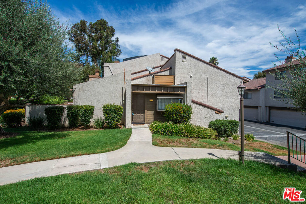 Beautifully updated 2-bedroom, 2-bathroom townhouse located in the highly desirable Warner Club Villas. This bright and inviting 1,067 sq ft unit features modern flooring, high vaulted ceilings, and abundant natural light throughout. Enjoy a spacious living room with a fireplace and dual sliding doors opening to a private patio, perfect for indoor-outdoor flow and entertaining. The home offers two generously sized bedrooms, including a large primary bedroom with vaulted ceilings and en-suite access. Updated vanities and fixtures in both bathrooms. Convenient in-unit laundry hookups. Attached garage with direct entry. Community amenities include: Resort-style pool & spa, Tennis courts, Lush landscaped grounds with walking paths. Perfectly situated in Warner Center, minutes from The Village, Topanga Mall, Warner Park, and the 101 freeway. HOA STRICT PET RULE - 1 PET, 30 LBS OR UNDER, NO EXCEPTIONS.