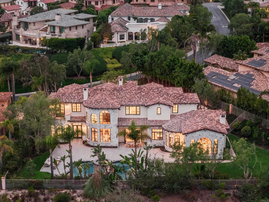Welcome to this reimagined estate in the exclusive guard-gated community of Rancho Pacifica. Recently transformed, this stunning residence blends timeless architectural elegance with elevated modern design. Step inside to discover soaring ceilings, expansive arched windows, and rich wide-plank white oak flooring that runs throughout. The heart of the home—an impeccably redesigned chef’s kitchen—features custom white oak cabinetry, double islands with quartzite countertops, all new Thermador appliances, and a stunning marble hood feature. The seamless flow into the bright family room and sun-filled breakfast nook creates the perfect backdrop for refined everyday living or effortless entertaining. On the main level, the spacious primary suite is a private retreat, complete with a spa-inspired bath with an oversized wet room with dual shower heads and dual oversized walk-in closets. Additional guest rooms are generously appointed, each with en-suite baths. Set on just over a half-acre lot with lush landscaping, the home features multiple outdoor entertaining areas and a resort-style pool and spa. Minutes to Del Mar, top-tier schools, golf clubs, and coastal access, this is luxury Southern California living at its finest. Properties of this caliber rarely come to market—don’t miss this exceptional opportunity.