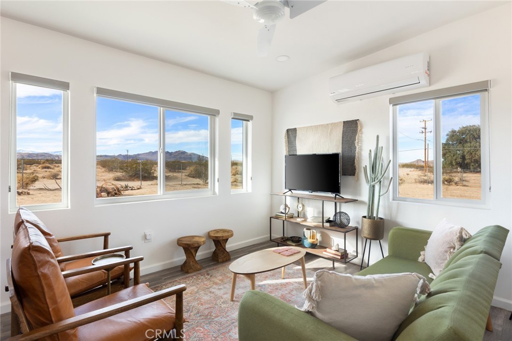 This reimagined desert retreat seamlessly blends modern luxury with the raw beauty of Joshua Tree. Just minutes from JT Village and the National Park, it offers the perfect mix of privacy and convenience. An open-concept design floods the space with natural light, framing stunning Mount San Gorgonio views. The sleek kitchen, with butcher block counters and high-end finishes, is perfect for casual mornings or lively gatherings. Two guest suites with spa-like baths provide serene escapes, while a separate guest studio offers endless possibilities -- additional sleeping quarters, creative space, or yoga sanctuary, backdropped by a striking 12-foot glass wall. Designed for effortless indoor-outdoor living, the property features two patios -- one for sunrises, the other with direct park views, plus an above-ground spa, fire pit, and hammock lounge. Comfortably sleeping 6-8, this home is both a retreat and a destination. Ready to make it yours?