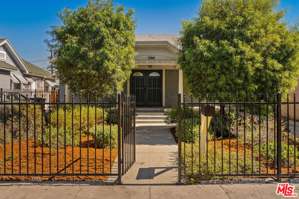 With an assumable loan at 3.1%*, this South Los Angeles property offers exceptional value in today's market. This versatile compound features a beautifully updated 3-bedroom, 2-bathroom craftsman bungalow plus a modern studio ADU with full kitchen and bath - perfect for multi-generational living or work-from-home space. Located just 0.4 miles from the Metro K Line, enjoy car-free access to LAX, the Expo Line, DTLA, Santa Monica and Culver City. This central location puts you minutes from SoFi Stadium, the Kia Forum, Intuit Dome and the growing Hollywood Park entertainment district. Enjoy popular Slauson Avenue restaurants including Jon + Vinny's, Somerville, and Hilltop Coffee. The new Vallarta Supermarket and the weekly farmers market at Baldwin Hills Crenshaw Plaza provide fresh local options. Step through the gated entry past drought-tolerant landscaping with efficient drip irrigation and butterfly-friendly, California native plants. The covered front porch, shaded by mature African Sumac trees, welcomes you home. Inside, you'll discover a spacious living room with original statement fireplace, open flow to a formal dining room and an updated kitchen, as well as French doors opening on to a private patio and expansive backyard. The large primary bedroom suite has a walk-in closet and an en-suite bathroom, while two additional bedrooms are flooded with ample natural light. A detached studio ADU includes a full kitchenette with stainless steel appliances, a full bath, mini-split heating and cooling system, its own washer/dryer, WiFi-enabled customizable LED accent lighting and a separate entrance. Outside, you'll find your own backyard retreat on a private 6,000+ square foot lot. A true urban oasis, it features mature avocado, lemon, lime and tangerine trees, lemongrass and passion fruit as well as drip irrigation and sprinkler systems. Kick back and host al fresco dinners under the twinkling wifi-enabled, color-changing string lights, allowing you to set the mood for any backyard occasion. A shed sits at the back of the ADU for additional storage. This home is perfect for first-time buyers, or anyone seeking versatile living in a prime central location. Come take a look. *Qualifying buyers can apply to assume the current loan.