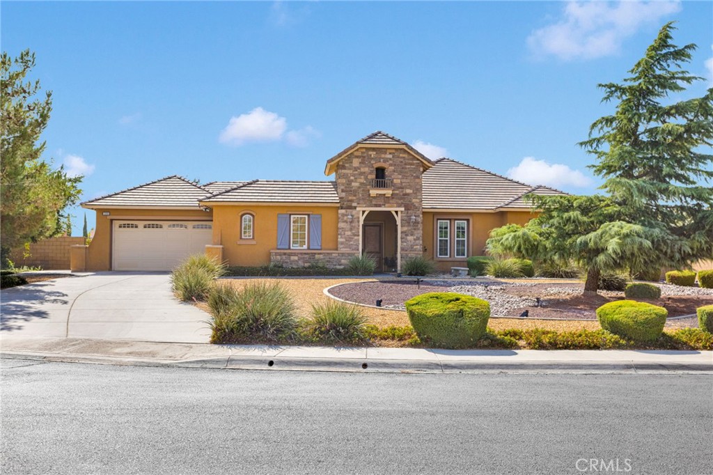 **Welcome to Your Dream Home in the Prestigious Gated Community of Ravenswood, Apple Valley!**
Situated in the heart of Apple Valley, this elegant 5-bedroom, 3.5-bathroom home offers 2,966 sq ft of thoughtfully designed living space on an expansive 18,293 sq ft lot. Built in 2008 and located in one of the most desirable gated communities, this property offers the perfect blend of luxury, function, and tranquility.
Step into the **grand entryway with soaring high ceilings** that create an immediate sense of openness and sophistication. The spacious interior includes a **large living room with a cozy fireplace**, a **formal dining or living area**, and a **versatile bonus room** that can easily serve as a **6th bedroom, home office, or playroom**.
The heart of the home is the gourmet kitchen, featuring a **massive granite island**, **dual sinks**, **double oven**, **walk-in pantry**, **butler’s pantry**, and **abundant cabinet space**—ideal for both everyday living and entertaining. Enjoy effortless flow to the outdoors through **grand French doors** that open from the kitchen, formal living room, and main bedroom to the beautifully landscaped backyard.
The **luxurious primary suite** offers ample space and privacy, with direct backyard access, a **spa-like ensuite bathroom** featuring **dual sinks**, a **soaking tub**, walk-in shower, and **his and hers walk-in closets**.
At the heart of the home, a **private courtyard** with a **low-maintenance koi pond** provides a peaceful, Zen-like retreat. The separate **casita** with its own entrance, full bath, and closet is perfect for guests, multi-generational living, or a private workspace.
Additional features include:
* **Dedicated laundry room** with large sink and cabinet storage
* **Newer tankless water heater**
* **Well-maintained backyard with mature landscaping**
* **Gated HOA with controlled access** for added security and peace of mind
Located just minutes from **top-rated schools**, shopping, restaurants, theaters, and the growing town center, this meticulously maintained home offers the perfect combination of comfort, elegance, and convenience.
**Don’t miss this rare opportunity to own a standout home in the coveted Ravenswood community—schedule your private showing today!**
