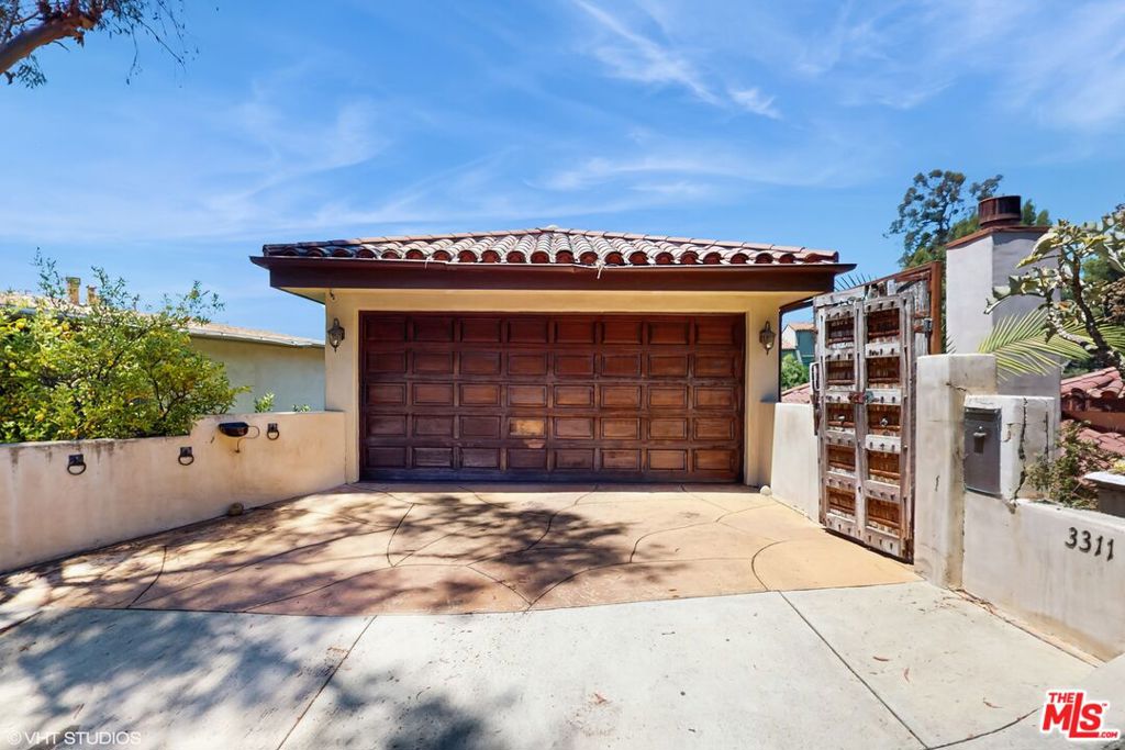 Nestled right under the iconic Hollywood sign in Beachwood Canyon and just a short stroll from some of LA's most incredible hiking trails. This stunning 4-bedroom, 5-bathroom home isn't just a place to live; it's an experience, ready to welcome its next long-term resident with open arms.Step inside and feel instantly at home with gorgeous hardwood floors guiding you through sun-drenched spaces. Wall-to-wall windows invite the spectacular outdoors in, framing picturesque vistas that will make every day feel special. Freshly painted and meticulously cared for, this home boasts a large, inviting kitchen featuring elegant stone countertops, a convenient walk-in pantry, and top-of-the-line Viking appliances perfect for whipping up your favorite meals.The primary bedroom is truly a sanctuary, a generous space designed for ultimate relaxation. Picture yourself unwinding by the cozy passthrough fireplace, enjoying its warmth from either your comfy bed or the luxurious primary bath. And what a bath it is! Dual vanity sinks, a refreshing waterfall shower, multiple sprayers, and a standalone tub create a spa-like escape. You'll also love the spacious walk-in closet with custom built-ins and your very own private balcony with a spa, an idyllic spot to soak in the views and let your worries melt away.Your loved ones or guests will feel right at home in the lower two secondary bedrooms, both featuring soft, cozy carpet, their own ensuite bathrooms, and incredible views with doors that open to a shared balcony perfect for morning coffee or evening stargazing.This isn't just a house; it's a lifestyle. Come discover your new beginning in the heart of the Hollywood Hills of Beachwood Canyon.