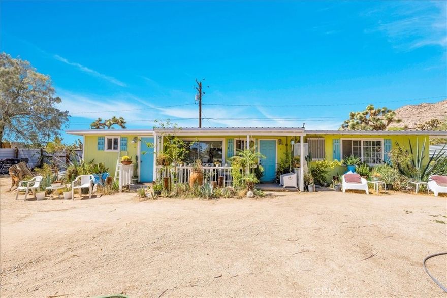 This charming 2 bedroom, 1 bath home on 1/3 acre in north downtown Yucca Valley combines comfort, style, and privacy with a convenient location. Beautiful landscaping and mountain views welcome you, along with a secure outdoor parking area and privacy fencing in both the front and backyard. Covered patios at the front and back of the home provide inviting spaces to relax outdoors in your own private oasis. Inside, the living room is spacious with high beamed ceilings, tile flooring throughout, and new windows that fill the space with light. The kitchen is nicely appointed and features an informal dining area with sliding glass doors to the backyard, plus a separate formal dining room for added flexibility. The bathroom is generously sized and includes a tub/shower combo. The first bedroom offers built-in storage and plenty of space, while the second bedroom is oversized with abundant natural light and large closet. A sizable bonus room provides even more versatility for work, hobbies, or guest use. Furniture is included, making this property move-in ready. With its thoughtful updates, spacious design, and excellent outdoor living features, this home is a wonderful opportunity in a desirable Yucca Valley neighborhood.