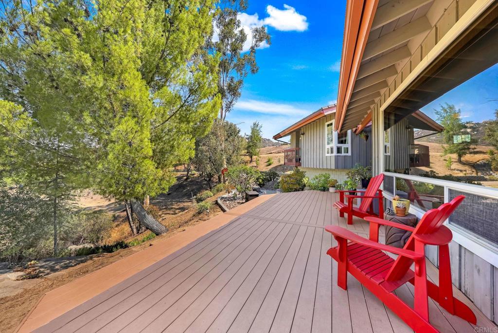 Beautiful home in coveted Palo Verde Ranch. Nestled at the end of a long, private driveway, this incredible secluded home is perfect for those wanting to get away from it all. Surrounded by mountains and incredible views, you really are in the midst of nature. Enjoy sipping your morning coffee on the large deck, taking in the scenery and enjoying the sounds of birds singing in the trees. Sitting on over 2 acres, there's lots of room to roam with ample parking for several cars and fruit trees throughout the property (avocados, guavas, peaches, mangos, pomegranates,...). The house has a spacious open floor plan with 5 bedrooms and 3.5 baths, gourmet kitchen, laundry room, fireplace, wood pellet stove, and lots of windows. The house also has central heat and AC. You're only a short stroll away from Palo Verde Lake. An incredible private lake perfect for swimming, paddle boarding, fishing or just floating around on a hot day. There's so much to do there. It features a clubhouse, dock, full gym, tennis and pickleball courts and even a sand volleyball court! Even though you're secluded in nature, it's only a short drive to restaurants, shopping and the 8 freeway (for a straight shot into San Diego). Come take a look at this beautiful property before it's gone. Call Mark at 619-865-5030.