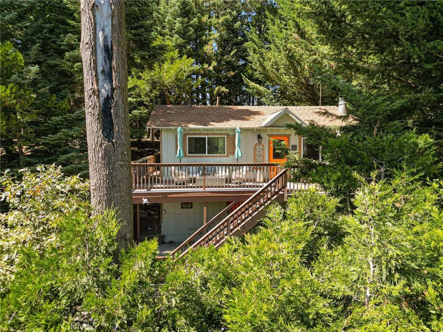 Escape to your very own mountain treehouse! This all one level living is in great shape and shows pride of ownership. Tucked in the trees you'll find a sense of privacy and solace here. The adjacent lot is included in the sale and really helps add extra privacy and charm to the setting. Once you make your way to the front door, you'll find 2 bedrooms and 1 bath all on the same level. When you escape out back there is a near full wrap around deck that allows you access to the back yard area where you can admire the mountain setting, trees and views. The current owners updated the main front deck with Fiberon composite decking, ridgecaps and H20 heater. The build up is large and should not be missed. In there you will find the laundry area and ample room for storage. There is even a full house AC unit. Located in Arrowhead Villas, and close to HWY 18 and the Lake Arrowhead Village. This has been a well running STR, has lots of parking, and the home comes mostly furnished minus sellers exclusions. Do not miss this one, it won't last long.