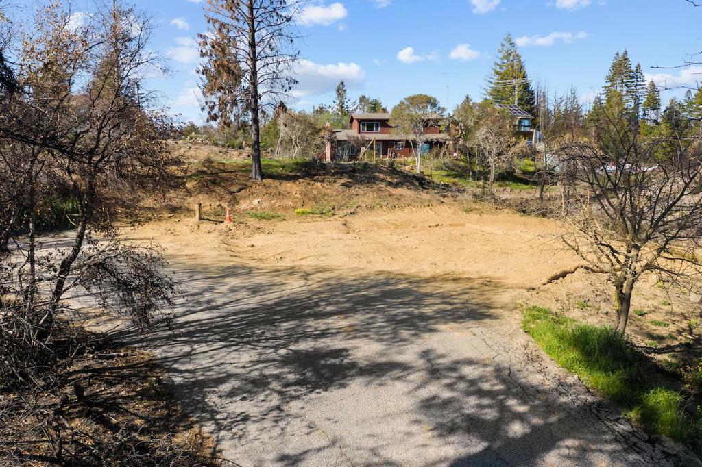 Private Bonny Dune 1.076 acre parcel with a peek of an ocean view. 2,432 square foot home was destroyed in 2020 CZU fires. Shared well. Electricity. The recent septic report is good (post-fire). Rebuild process to be expedited through County Recovery Permit Center (RPC) cooperation. Permit applications to receive special processing with reduced building permit fees for lots like this that suffered from CZU fire loss. Sunny lot in a desirable neighborhood where you will see deer, birds and other wildlife. Only a 15-minute drive to the west side of Santa Cruz where you will find your favorite beaches, shops, and restaurants. Come fall in love with this special property!