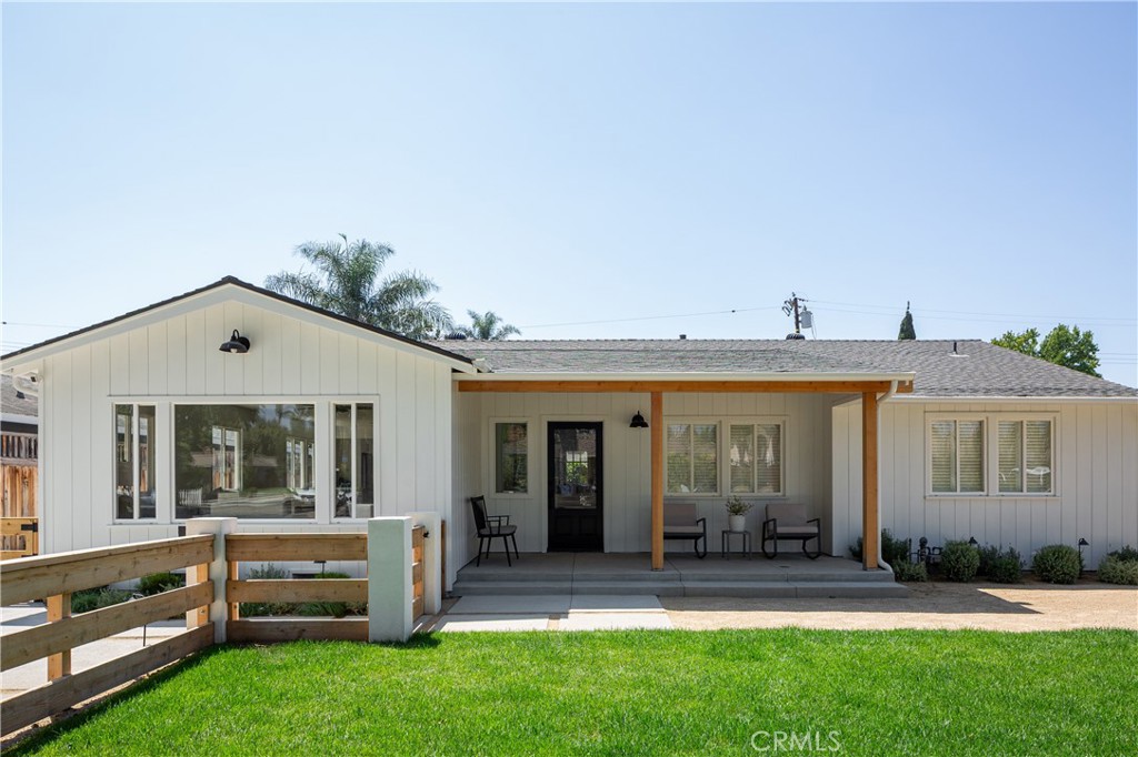Welcome to 158 N Maplewood Ave — a beautifully refreshed 3-bed, 2-bath home that blends timeless bungalow charm with modern coastal style. Nestled on a tree-lined street near the heart of Old Towne, this thoughtfully updated home sits on a generous 7,800 sqft lot and offers the perfect balance of comfort, character, and convenience. The newly reimagined exterior features fresh paint, a redesigned front porch, and custom horizontal fencing, creating a warm, inviting first impression. Inside, the open-concept layout has been completely opened up for seamless flow between the living, dining, and kitchen areas—ideal for entertaining or everyday living. Wide-plank luxury vinyl flooring, dual-pane windows, recessed lighting, and a soft neutral palette bring light and cohesion to the space. The kitchen is a true showstopper with white shaker cabinetry, Quartz countertops, stainless steel appliances, and a full-height subway tile backsplash. The expanded primary suite offers a peaceful retreat with an oversized en suite bath featuring dual vanities and a glass-enclosed walk-in shower. Two additional bedrooms share a beautifully renovated hallway bath with a soaking tub and designer finishes. A dedicated laundry room with a Dutch door provides charm and functionality, opening to the spacious backyard. Outdoors, you’ll find drought-tolerant landscaping, a covered patio for al fresco dining, and ample room to entertain or unwind. With plenty of space to add an ADU extended from the detached two-car garage or a pool, this backyard offers endless potential for future value and flexibility. Located just minutes from Orange Circle, Chapman University, the Hilbert Museum, local parks, and the train station - plus proximity to highly rated public and private schools. Opportunities like this don’t come along often - don’t miss your chance to own a piece of Orange with room to grow!