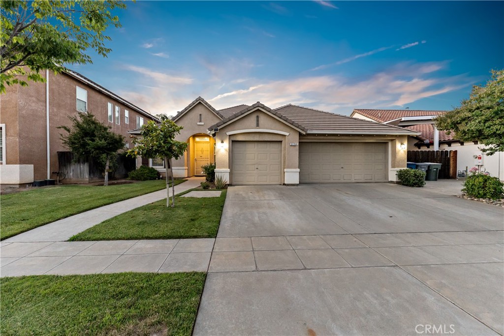 Discover your dream home in the heart of a desirable Clovis neighborhood! This beautiful residence welcomes you with two inviting living spaces, perfect for family gatherings or quiet evenings. The formal dining room sets the stage for unforgettable meals, while the spacious kitchen with ample cabinetry, clean tile countertops, and a large island invites culinary creativity. Retreat to the luxurious master bedroom ensuite, complete with dual sinks, a relaxing tub, and an expansive walk-in closet that caters to all your storage needs. Enjoy high ceilings and ceiling fans in every bedroom for ultimate comfort. The downstairs office can easily be converted to a 5th bedroom is desirable. Plus, the generous three-car garage offers plenty of space for your vehicles and hobbies. Step outside to your personal oasis - an enchanting backyard designed for relaxation and entertaining. With a covered patio and lush green grass complemented by fruitful orange, apricot, and lemon trees, you'll have everything you need to enjoy sunny days with friends and family. And let's not forget the unbeatable location! You'll be just minutes away from scenic walking trails and community parks that enhance your lifestyle. Don't miss out on this incredible opportunity - schedule your private showing today and make this beautiful house your forever home!