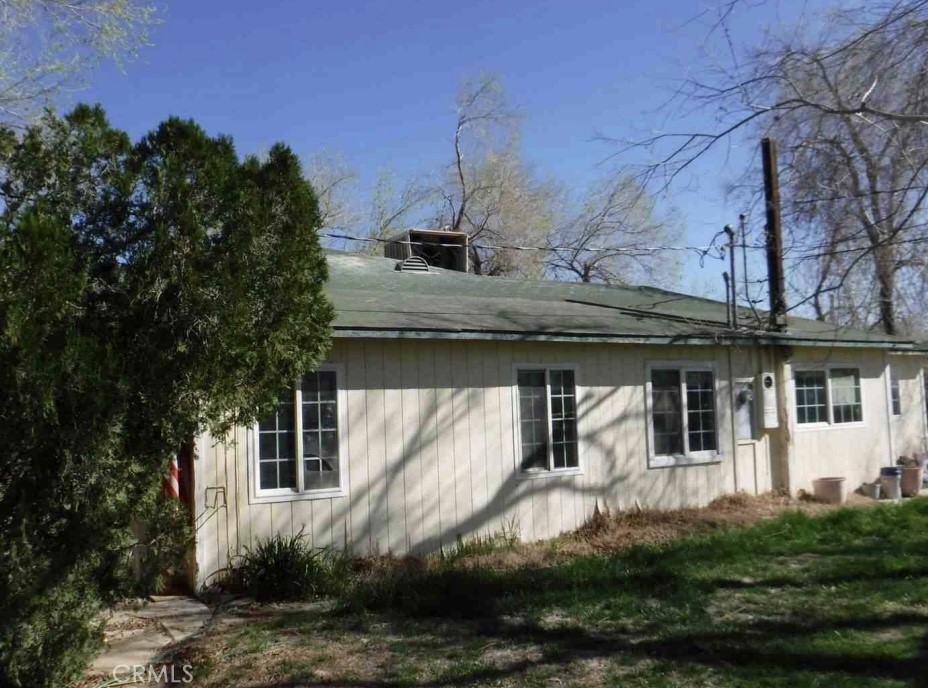 Opportunity knocks in the wide-open expanse of West Lancaster with this unique fixer-upper brimming with potential. Originally permitted as a two-bedroom, one-bath home totaling 903 square feet, the property has seen some expansion over the years. Currently, there’s an unpermitted addition reflecting up to four bedrooms and two bathrooms and approximately 2,458 square feet of total space—ideal for those with a big imagination and a solid renovation plan.
Set on a sprawling and largely untouched 20-acre desert lot, this property offers endless possibilities for outdoor enthusiasts, hobby farmers, or anyone with a dream of wide-open space. Multiple outbuildings, including barns and a former printing shop, add character and utility.
The property requires significant repairs, including a new roof in addition to making it best suited for investors or buyers ready to roll up their sleeves. But with the right touch, this rural retreat can be transformed into something truly exceptional.
