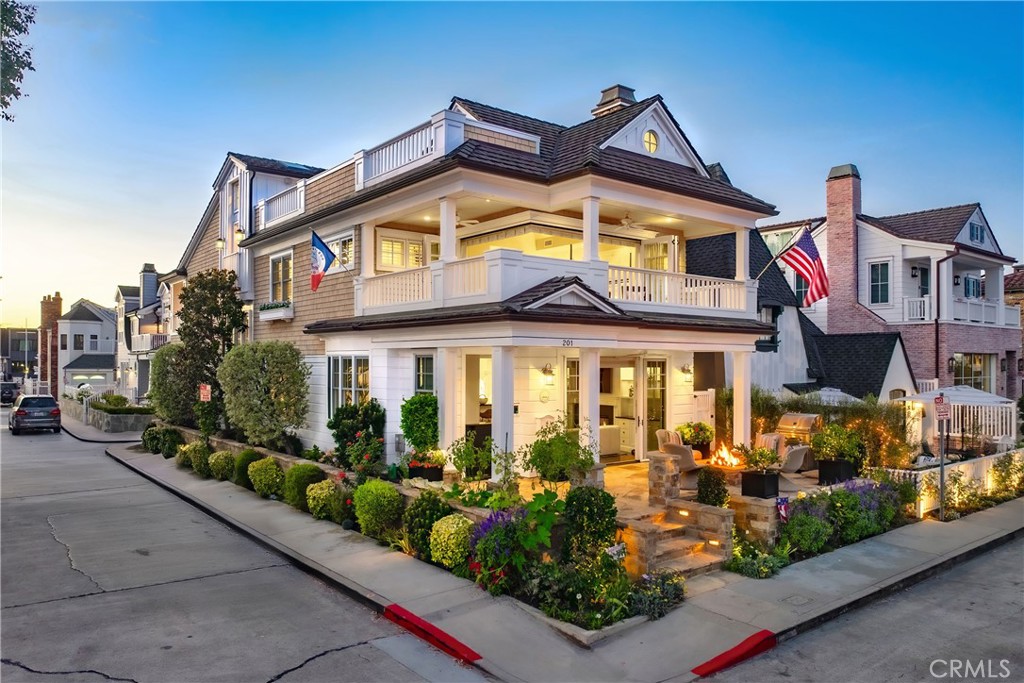 Outstanding opportunity to own a one-of-a-kind corner residence on the quiet end of Balboa Island. The first level features a spacious front deck with fireplace surrounded by lush landscaping, a large great room with fireplace and built-ins, a separate seating area, dining area, chef’s kitchen with walk-in pantry, and a guest bath. The second level showcases a primary suite with vaulted ceilings, office alcove with built-ins, spa-like bath with soaking tub, walk-in shower, expansive closet, and folding doors opening to a wraparound balcony with peekaboo Bay views. The second level also includes a sizable den/office space with built-in desk, a wet bar, two generous guest bedrooms with a balcony and bath, and a laundry room. The third level offers a covered loggia with bar and mini-fridge, storage, and an impressive roof deck with fireplace and room for a spa. The home also includes a two-car garage, outdoor shower, room for a golf cart, and much more. A rare chance to own a signature home in an exceptional location.