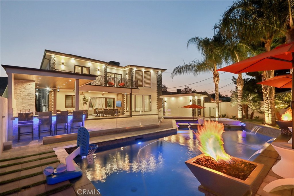 Granada Hills Stunner!!! Gated Mediterranean inspired 2-story Masterpiece where you find elegance in every inch in this home. An attractive exterior sets the tone for this remarkable home where quality craftsmanship meets modern artistic design with the variety of textures and materials that successfully come together for an elegant-yet practical appearance. Remodeled to perfection in 2018, this 5 bedroom, 5.5 bathroom beauty provides over 4,000 SQFT of comfortable living space with lavish details throughout, including the bathroom with Spa Tub, large balcony overlooking the pool from the second floor, and so many wonderful features including Raxoll insulation and presidential three layered roofing. Creative custom double door entry with striking chandelier, foyer opening to the rest of the home with dramatic high ceiling, recessed lighting, Italian custom painting, tiles from Italy and Spain and a beautiful fireplace. You will appreciate the Mielle high-end appliances, the uniquely designed lighting system, LED smart control system, surround sound in the living room, family room and patio with security cameras around the house. All bedrooms and living areas are hardwired for network and TV. Just in time for Summer. Outside is an entertainer's paradise featuring pool/hot tub with water & fire features, the latest version of high-end Pantere pool equipment with a smart remote controlling system, covered patio with ceiling fans and built-in heaters, custom built covered BBQ area, outdoors bathroom and sauna and so much more. By far one of the best homes listed in Granada Hills today!!!