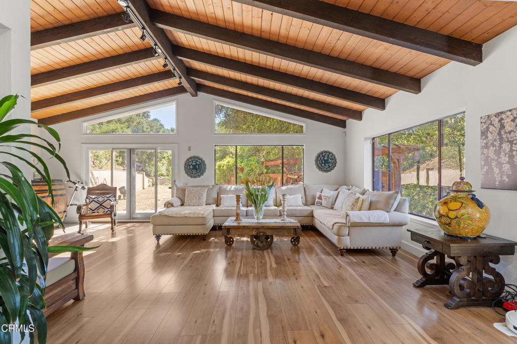 Tucked away on an expansive 43,995 sq ft lot, this picturesque Oak View property offers the perfect blend of natural tranquility and modern comfort. Surrounded by mature trees and vibrant landscaping, the home is embraced by sweeping views that create a peaceful, private atmosphere.A long, gently sloping driveway leads you to the 2,467 sq ft residence, where an inviting outdoor space near the main entrance sets the tone for relaxed living. Step inside to discover a spacious living room adorned with exposed wood beams, rustic wood flooring, and an impressive stone fireplace that brings warmth and character, ideal for cozy winter evenings. Sunlight pours through large windows, enhancing the natural beauty of the interior.The open-concept kitchen is a chef's dream, featuring stylish gray cabinetry, sleek stainless-steel appliances, and a generously sized dining area that invites family gatherings and effortless entertaining. A convenient half bath is located on the main floor.Upstairs, the serene primary suite offers a luxurious escape, complete with a spa-like bathroom that includes a soaking tub, dual vanities, and a spacious walk-in closet. Two additional bedrooms share a well-appointed full bathroom and enjoy direct access to a balcony with stunning views of the surrounding landscape.The expansive backyard is a true highlight offering endless possibilities for outdoor entertaining, gardening, or simply soaking in the natural beauty of the setting. Whether you're looking for a peaceful retreat or a place to host unforgettable gatherings, this Oak View gem has it all.Don't miss this rare opportunity to own a slice of scenic paradise!