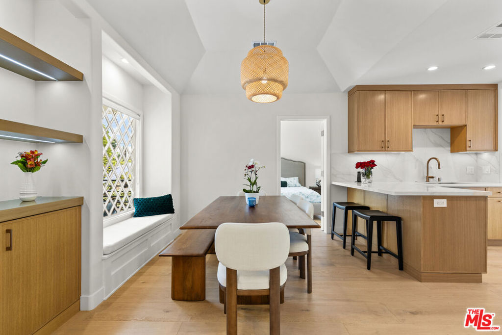 Charming Santa Monica bungalow, meticulously rebuilt from the ground up while preserving its original footprint and timeless character filled with Love! Featuring soaring ceilings, custom-built cabinetry throughout, and restored front windows complemented by custom wood windows to match. The living room centers around a stunning fireplace with handmade Moroccan Zellige tiles, while the chef's kitchen boasts high-end stainless steel appliances, granite countertops, and handcrafted cabinetry. French doors in the kitchen and primary suite open to a lush, private backyard with mature orange and persimmon trees and blooming rose vines. All bathrooms are elegantly finished with Porcelanosa tiles from Spain. The detached garage has been transformed into a fully permitted ADU with its own designer kitchen and bathroom, perfect for office, guests or rental income. Ideally located north of Wilshire, just moments from Montana Avenue, Ocean Avenue, and easy freeway access