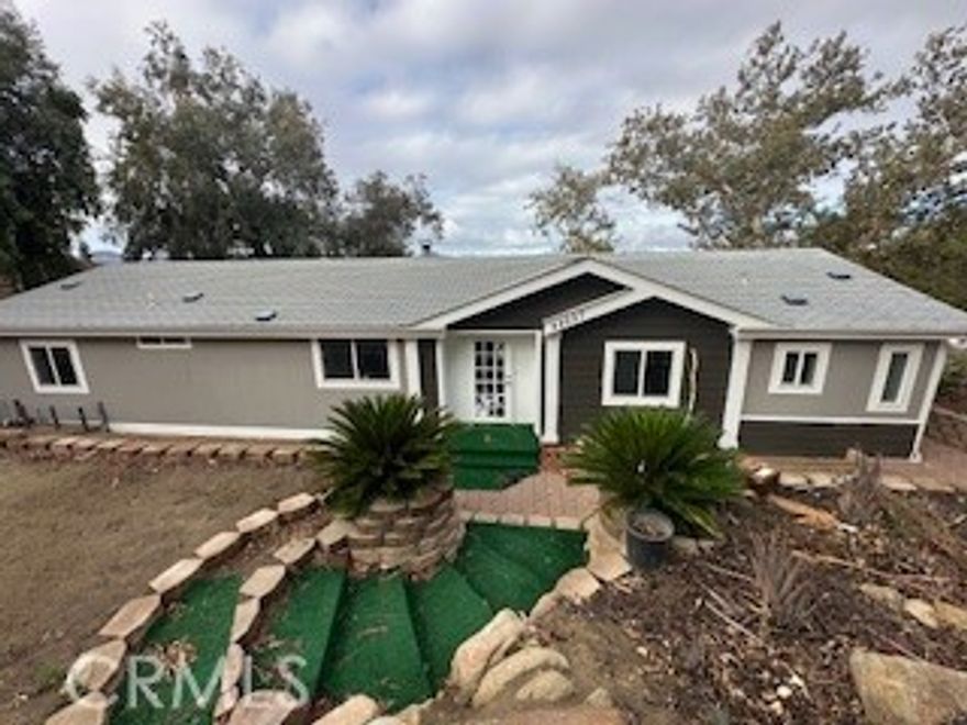 Welcome to 42557 Gibbel Road, Hemet, CA 92544 — a stunning custom-built home offering peaceful country living with breathtaking lake views!

Built in 2004, this beautiful residence features approximately 2,187 sq. ft. of living space on a sprawling 6.32-acre lot, providing both privacy and room to grow. Inside, you’ll find 3 spacious bedrooms, 2 full bathrooms, and an additional office that can easily serve as a fourth bedroom.

The open-concept floor plan is highlighted by large windows that fill the home with natural light and frame the picturesque views. The kitchen offers ample counter space and cabinetry, ideal for both everyday living and entertaining. The inviting living room features a cozy atmosphere perfect for relaxing or hosting family gatherings.

Step outside to the expansive deck overlooking the lake, where you can enjoy serene mornings and relaxing evenings surrounded by nature. With plenty of outdoor space, there’s potential for gardening, animals, or simply enjoying the tranquility of the surroundings.

Experience country living at its finest — peaceful, private, and just a short drive from local amenities. Don’t miss the opportunity to make this Hemet gem your new home!