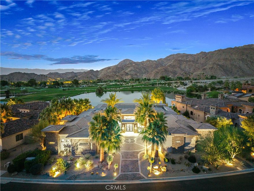 Set on one of the most exclusive vantage points in Ironwood Country Club, this residence captures the true essence of desert serenity. Walls of glass frame uninterrupted vistas across a reflecting lake, the rolling fairways of the two championship courses and to the rugged ridgelines of the Santa Rosa and Chocolate Mountains. At night, tranquility reigns with star filled skies, the radiant hush of the desert, and glowing panoramas that create a natural masterpiece. 
The home spans 6,265 square feet across a private 19,600-square foot lot, designed with a modern, organic, desert centric architecture that blends seamlessly with its natural surroundings. An elegant motor court, framed by palms, water features, and desert landscape welcomes you home. Inside, refined living spaces and walls of glass with 14 foot ceilings open to breathtaking views at every turn. A modern, entertaining kitchen with seating for many, a butler’s pantry with coffee bar, a mountain view dining room, a 1,500-bottle wine room, a private viewing room with huge pivot doors, and a gym, all elevate your everyday living. Each of the four ensuite bedrooms offers its own retreat, including a luxurious private casita with a spa-inspired bath with waterfall shower. The primary suite enjoys exceptional views, two walk-in closets, fireplace, sitting area, and direct access to the pool and spa—perfect for savoring desert nights in solitude.
Ironwood Country Club is a private, member-owned community cradled by the Santa Rosa and San Jacinto Mountains National Monuments. Just moments from El Paseo yet worlds away in ambiance, this rare offering combines natural beauty, ultimate privacy, and a lifestyle defined by peace, exclusivity, and awe-inspiring desert landscapes.