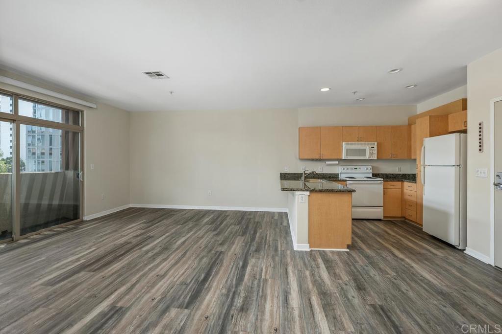 Conveniently located next to Little Italy, I5 Freeway, San Diego Bay, downtown shopping and more! This stylish condominium offers modern living with 2 bedrooms and 2 bathrooms on 1063 sq ft of contemporary living space! This elegant Palermo condo unit was built with numerous upgrades and added amenities: 2BD/2BTH Gated, underground parking with TWO reserved spaces and guest parking! Granite countertops in kitchen and bathroom New laminate wood flooring Tile floor bathrooms Fully equipped appliances including self-cleaning oven, microwave, and in-unit washer/dryer Air conditioning Stainless steel kitchen sink w/ garbage disposal High, nine-foot ceilings European natural maple laminate cabinets Fully insulated exterior walls and floors Sparkling pool and spa with spacious sun deck and BBQ area Fully equipped business center with private offices, FAX machine, printers and restroom. Club room with kitchen and television for entertaining. Fitness center with state of the art cardiovascular and weight equipment. Controlled access building entry with intercoms A one year lease is preferred. One-year lease is preferred then goes month-to-month. Owner covers trash and utilities.