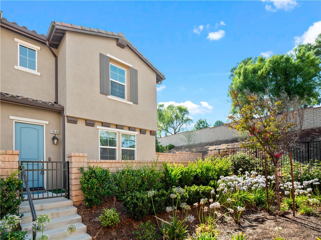 Rare Valencia West Creek home in Santa Clarita with its own private yard and featuring 3 bedrooms, 2.5 bathrooms, loft and an open-concept great room perfect for modern living. The upgraded kitchen boasts a center island, granite counters, white cabinetry, stainless steel appliances, and abundant storage. Tile floors on the first level, guest powder room, and private yard with putting green and no rear neighbors enhance this home’s appeal. Upstairs offers a loft perfect for a play room, home gym or office, spacious primary suite with walk-in closet, and ensuite with dual sinks and glass-enclosed walk-in shower.Two bedrooms, a dual-sink bathroom to share and conveniently located laundry room with storage. Enjoy West Creek HOA amenities—rec center, pools, basketball court, parks, paseo trails—near award-winning West Creek Academy, Rio Norte Jr High, and Valencia High. Prime location with easy freeway access, close to Westfield Valencia Town Center, dining, and entertainment.