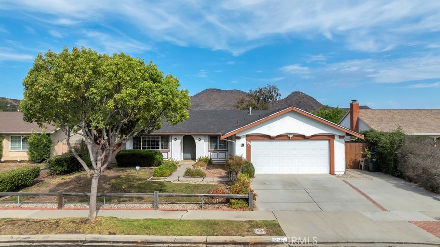 Welcome to this charming single-story 4-bedroom, 2-bath home on a BIG lot in the heart of Newbury Park, offering breathtaking mountain views! This well-maintained residence features a new roof, new main sewer line, newer wood flooring and fresh interior paint throughout. The inviting open floor plan includes a spacious living room with a cozy fireplace that flows seamlessly into the dining area and kitchen. The kitchen offers ample counter space and picture-perfect views of the backyard and surrounding mountains. The primary suite includes an upgraded bathroom with direct access to the backyard, creating an ideal retreat. Additional highlights include updated bathrooms, dual-pane windows and sliding doors, and a newer side-yard fence. Step outside to a large backyard with mature fruit trees, nice landscaping, and automatic sprinklers—perfect for relaxing or entertaining. The property also offers a two-car attached garage with a workbench, additional RV/boat parking, and an indoor laundry room for added convenience. Excellent potential to add an ADU, offering increased living space or rental income opportunity. Do NOT miss the opportunity to make this move-in-ready home your own!