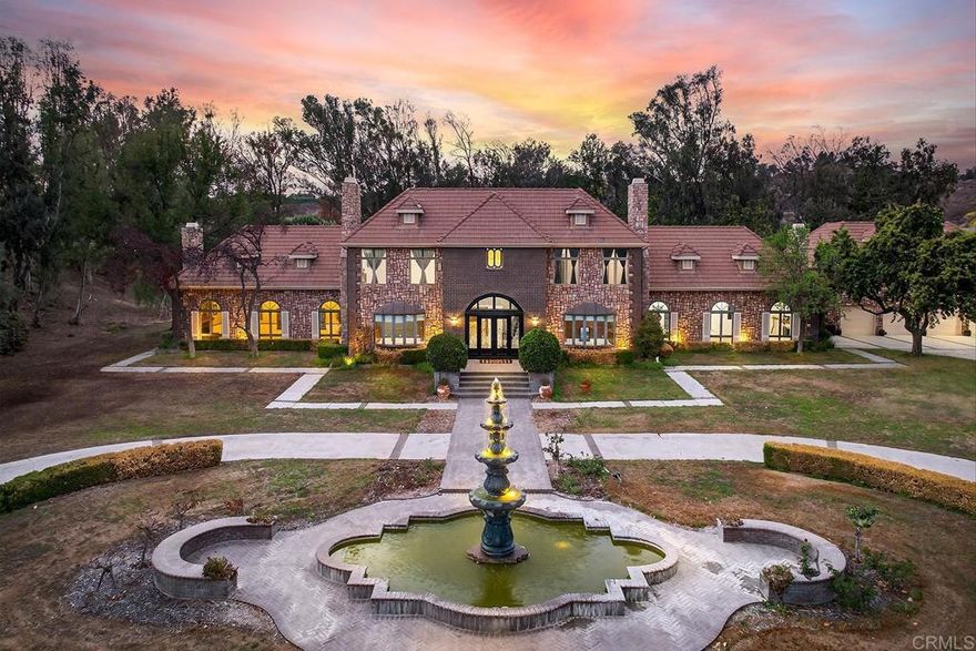 Welcome to a timeless 10-acre estate along Temecula’s famed De Portola Wine Trail — a private and gated retreat where Wine Country living meets elegance, tranquility, and endless opportunity. Beyond the beautiful custom entry gate, you’re greeted by lush landscaping, a circular driveway with fountain, and sweeping panoramic views that stretch across vineyards, valleys, and surrounding mountains. Every detail of this 10,000 SQ FT residence was designed to offer beauty, comfort, and connection.  Inside, the home offers grand living and entertaining areas, including two great rooms (previously used as a game room and ballroom), a formal dining room, library, and an upgraded gourmet kitchen with Viking appliances perfectly suited for memorable gatherings. A private elevator leads to the second story, which hosts a sauna, the serene primary suite with dual cedar-lined walk-in closets and a luxurious spa bath, as well as two secondary bedrooms with private en-suite bathrooms. Fine finishes are showcased throughout — from the grand custom entry doors and marble floors to the sweeping staircase crowned by a commanding chandelier, and the warmth of seven fireplaces that create an inviting ambiance throughout the home.  Outdoors, enjoy your own resort-style amenities — a newly replastered Olympic-size pool, spa, multiple entertaining spaces, a private nine-hole golf course, and an orchard filled with mature fruit trees. The property also features a picturesque pond, currently drained but ready to be restored to its tranquil beauty. The separate guest quarters above the four-car garage offer two bedrooms and two full baths with space for a sitting area or kitchenette— ideal for guests, extended family, or multi-generational living.  With over 10 acres of usable land, this property qualifies for a winery permit and offers potential for an equestrian estate, bed and breakfast, event space, or private vineyard. Priced to sell, this extraordinary estate represents a rare opportunity to create your own legacy in Temecula Wine Country — and enjoy the peace of wide-open spaces just minutes from local wineries, dining, and shopping.