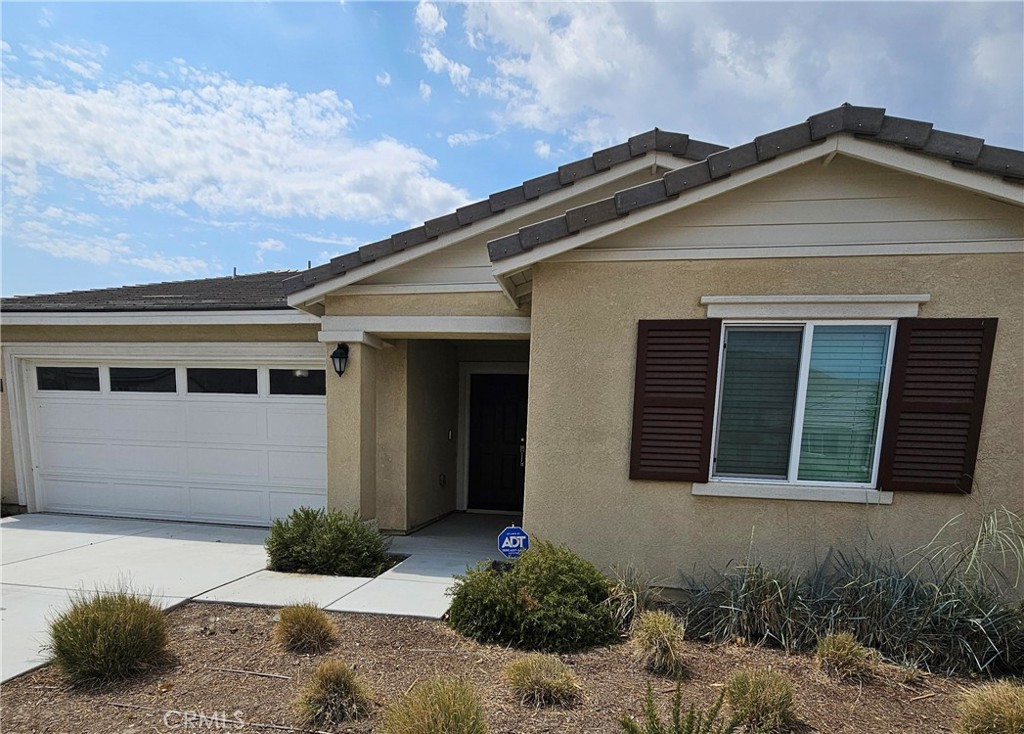 Turnkey Single-Level Home with Mountain Views | Built in 2023 Meticulously maintained single-story with owned solar | No HOA | EV-ready Set on a quiet street with no HOA, this beautifully kept 1,576 sq. ft. home blends traditional curb appeal with modern efficiency. A professionally landscaped front yard with decorative rock accents and a welcoming covered porch lead into a wide entry hall and an airy Great Room with vaulted ceilings and a sun-filled dining area. The island kitchen is built for everyday living and entertaining—granite countertops, smoke-colored shaker cabinets, stainless Whirlpool built-in gas range, microwave and dishwasher, breakfast bar, and pantry. The private primary suite features an expansive en-suite with a walk-in shower (with bench), dual-sink vanity, private toilet room, and a large walk-in closet. Two additional bedrooms and a full guest bath are set across the home for ideal separation. Highlights: 3 bedrooms | 2 bathrooms | 1,576 sq. ft. single level Fully paid-off solar panels for energy savings Smart-home technology Direct-access 2-car garage, EV-charging ready Laundry room with washer, dryer, and extra linen storage Window blinds throughout Low-maintenance yard with beautiful mountain views Moments to schools, running paths, hiking trails, Soboba Casino Resort and everyday conveniences—this home delivers comfort, efficiency, and a great location without HOA fees. Ready for your personal outdoor touch.