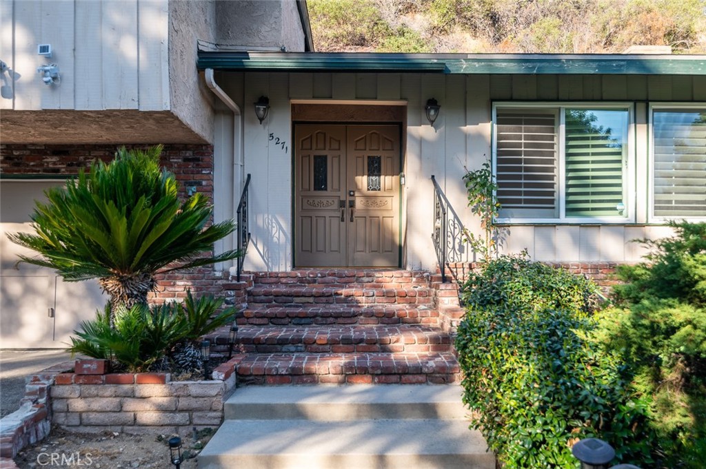 Enjoy La Canada lifestyle in this charming traditional home with mid-century flair located in one of La Canada Flintridge's most exclusive & peaceful hillside neighborhoods.. This wonderful home offers privacy and seclusion yet is close to school and town. Located at the end of the private road on a tranquil cul-de-sac in Gould neighborhood of La Canada Flintridge. The formal living room features vaulted ceilings and brick fireplace. It is open to the generous formal dining area, family room, and updated kitchen, making space an entertainer's dream. An expansive family room is enhanced with brick fireplace and original built-ins. Sliding doors lead to a private patio on both sides overlooking peaceful backyard with views of the nearby picturesque hills creating a serene retreat. The backyard is a stunning natural extension of the home, offering a variety of peaceful outdoor living spaces and multiple seating areas. Back inside the home are 3 bedrooms including a private master suite. Attached 2-door garage includes plenty of room for storage, laundry room, and other options. Central heat and air. Conveniently located near hiking trails, local shopping, and award winning La Canada Schools.