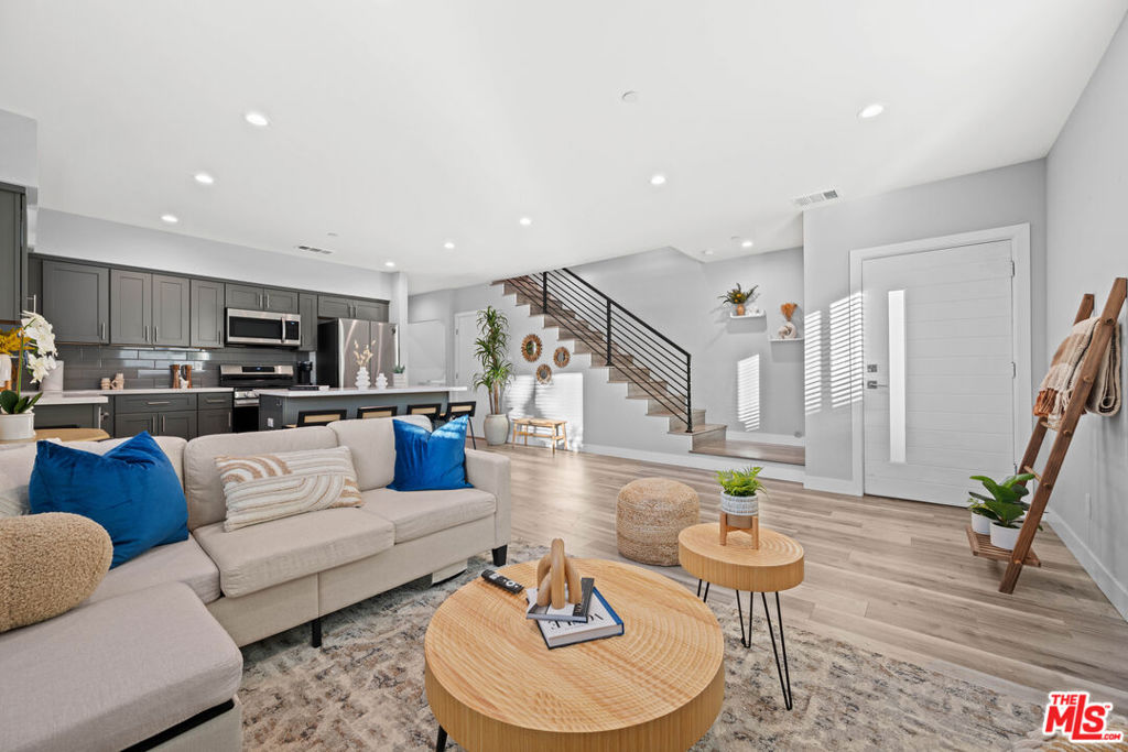 Stunning 4 Bedroom + Parking townhome! Hardwood floors, recessed lighting, stainless steel appliances, in-unit laundry. Open-concept kitchen and living area. The modern kitchen is equipped with stainless steel appliances (refrigerator, stove/oven, dishwasher, and microwave) and offers ample cabinet space for storage. A washer and dryer are conveniently located near the kitchen. Central air and heating ensure year-round comfort. The spacious primary suite includes a walk-in closet.