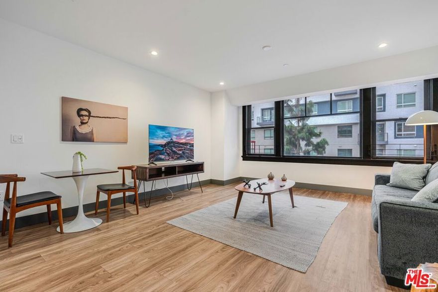 Experience elevated downtown living at The Piano Lofts, located at 932 South Hill Street in the heart of DTLA's vibrant South Park district. This fully furnished 2-bed/1-bath residence blends industrial design with modern comfort, featuring soaring ceilings, polished concrete or hardwood floors, and expansive windows that fill the home with natural light. The spacious open layout creates a seamless flow between living, dining, and kitchen areas, ideal for both relaxing and entertaining. The contemporary kitchen is equipped with stainless steel appliances, sleek cabinetry, a microwave, a dishwasher, and a full-size refrigerator. A private balcony offers the perfect spot to enjoy city views and fresh air. Convenience abounds with an in-unit washer and dryer, stylish furnishings, and thoughtful design details throughout. The bedroom provides generous closet space and abundant natural light, while the modern bathroom includes upgraded finishes and designer fixtures. Every element has been curated for a comfortable, turn-key lifestyle.  Located moments from LA Live, Crypto.com Arena, Whole Foods, and some of the city's best dining, shopping, and entertainment, The Piano Lofts offer the ultimate downtown experience. This is more than a homeit's a lifestyle defined by creativity, energy, and modern luxury.