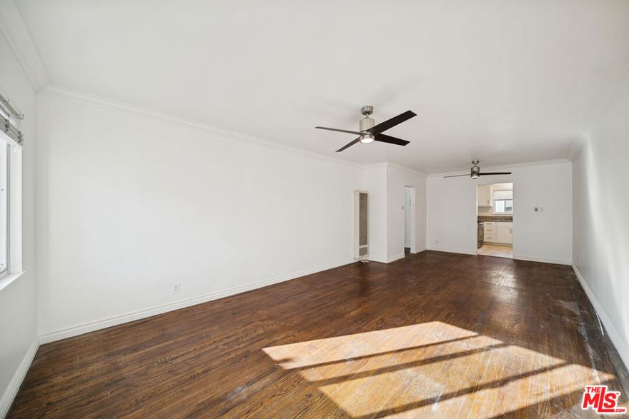 This approximately updated 2-bedroom, 1-bath residence offers a bright and comfortable layout enhanced by hardwood flooring, fresh interior paint, new ceiling fans, and updated lighting throughout. Large windows provide abundant natural light, creating an inviting living environment. The kitchen features hardwood cabinetry and stainless steel appliances, including a refrigerator, designed to support everyday functionality. Tenant pays gas, electricity, and trash; owner pays water. Parking is available for an additional monthly fee. All features, measurements, and availability are approximate; tenant to independently verify all information.