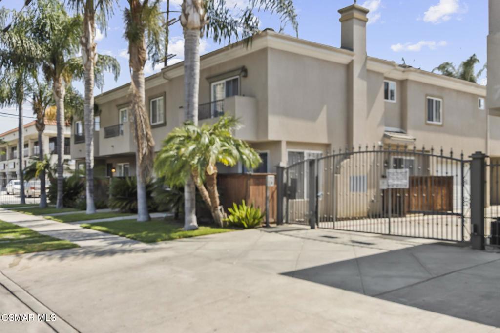 Don't miss this rare 4 bedroom, 2.5-bathroom, 1,608 sq ft end-unit townhome in a gated community near Warner Center and The Village. The open concept main floor features hardwood floors, recessed lighting, a living room with a decorative fireplace that flows into the dining area and kitchen with granite counters, island, and full suite of appliances.Step outside to a private and spacious low maintenance yard with a pergola perfect for relaxing or entertaining. Enjoy the convenience of an attached 2 car garage with storage and an upstairs laundry area.Upstairs, you'll find four spacious bedrooms including a primary suite with a walk-in closet, private balcony, and en-suite bath. Additional features include ceiling fans and a tankless water heater.Located just a block from the famous Cavaretta's Italian Deli and close to shopping, dining, and freeway access.