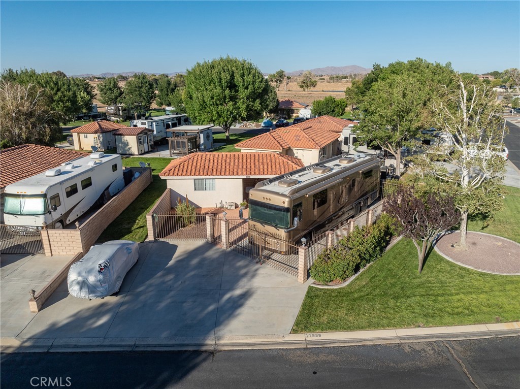 Discover the perfect outdoor living experience with this exceptional corner lot in the vibrant Jess Ranch RV Lot community! This beautifully landscaped parcel spans an impressive 4,500 sq. ft. and features lots of concrete, ample parking space, lush grass, elegant block walls, and secure wrought iron gates, offering both privacy and charm.
At the heart of the lot is a well-appointed 200 sq. ft. storage unit, equipped with a stackable washer and dryer, a refrigerator, and ample storage cabinets. A convenient water softener system and automatic sprinklers further enhance this versatile property.
Imagine the possibilities: expand your current storage or add a cozy casita for guests! Enjoy the family-friendly atmosphere of the community, complete with a welcoming clubhouse, pool, clean shower facilities, and laundry services.
This gated community is brimming with opportunities for relaxation and recreation. Don’t miss your chance to embrace outdoor living in a thriving neighborhood—this lot is a true gem! Please note that buyers have the right to investigate all aspects of the property, and all information provided should be verified through their own inspections.