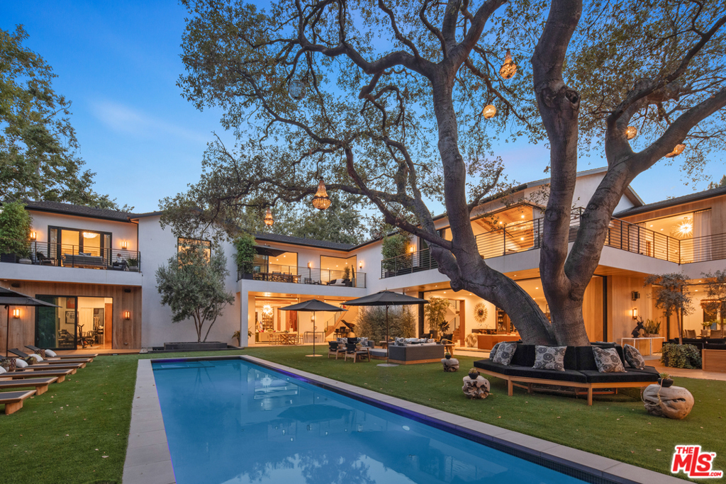 Positioned within the secluded enclave of Royal Oaks in the exclusive Encino neighborhood of Los Angeles, this contemporary masterpiece features 9 bedrooms, 11 bathrooms, all situated upon almost one acre of private property. Across the property, extensive upgrades have taken place, including a beautiful spa, a spacious gym, stunning chandeliers, an extensive surround sound system, a state-of-the-art theatre, and an expansive security system. Outfitted with the highest grade of designer materials, from aged natural woods and imported stones, to European cabinetry and heightened ceilings, to walls of glass and oversized sliding doors, the home offers the best in luxury living while maintaining an effortless indoor/outdoor lifestyle. Alongside the main home is a lap pool with spa, accompanied by a substantial 2 bedroom guest house complete endless entertainment amenities such as an aquarium, cigar humidor, kegerator, fog machine, disco lights, and covert DJ station. Additional features of the property include a 4-car garage, turf landscaping, putting green, outdoor projector, secondary prep kitchen, custom wine cellar, expansive outdoor patios, and private balconies.