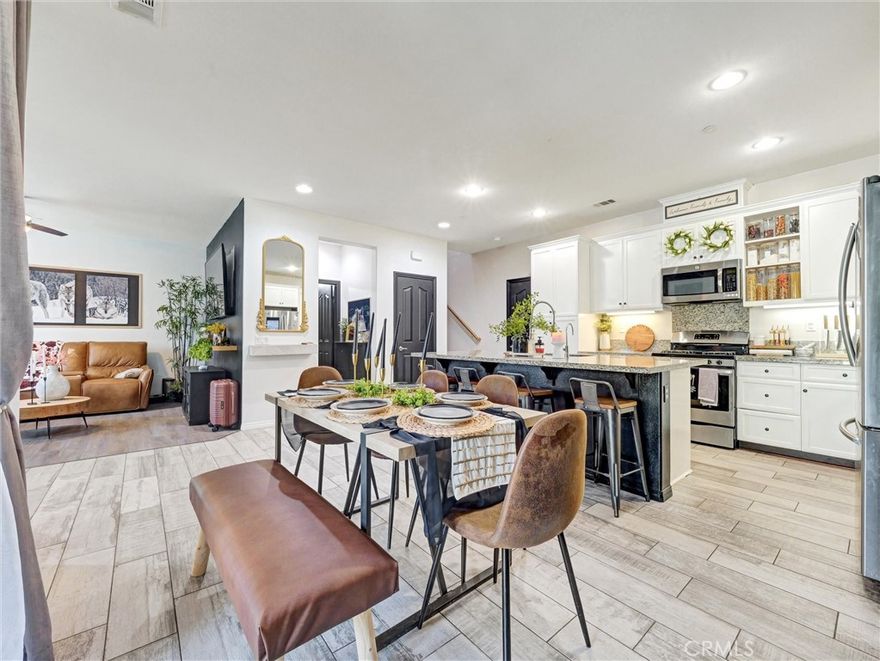 Welcome to this beautifully maintained 2 bedroom, 2.5 bath condo offering modern comfort and thoughtful design. The open-concept main floor features a spacious living room, dining area, under stairway room or storage and a fabulous kitchen—ideal for both entertaining and everyday living. You'll love the granite countertops, stainless steel appliances, and the centerpiece: a huge granite kitchen island with plenty of space for prep, dining, and gathering. A convenient half bath is also located downstairs for guests.

Upstairs, you'll find two private suites. The generous primary suite features an ensuite bathroom with a separate tub and shower and a large walk in closet space with designer lighting. The second bedroom is a junior suite with its own private bath—perfect for guests, roommates, or a home office. A full-size washer and dryer are included and conveniently located upstairs.

Additional highlights include a 2-car garage with direct access and include the glass door cabinets for extra storage.

This home is located in a vibrant, amenity-rich community. Residents enjoy exclusive access to a beautifully appointed clubhouse offering complimentary Wi-Fi, cozy lounge areas, TVs, a baby grand piano, and a welcoming space to meet and mingle. Stay active with a 24-hour fitness center and dedicated kids’ playroom, or host gatherings in the spacious multi-purpose room. Outdoors, unwind at one of two sparkling pools, the spa, or the splash zone for kids. Cabanas with showers, outdoor fireplaces, BBQ areas, and a variety of games complete the resort-style experience. Whether you're grabbing a free coffee or connecting with neighbors, this community offers the perfect blend of comfort and connection.

Don’t miss out—Schedule your private tour before it’s gone!