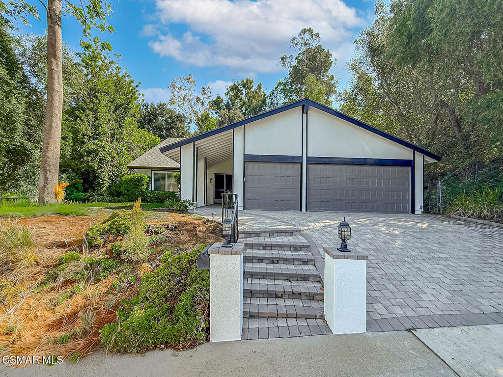 This turn-key home has been freshly painted inside and out, has new waterproof flooring, new recessed lighting throughout, new bathroom vanities and fixtures and a newly epoxied 3-car garage. Tucked in the scenic Santa Monica Mountains, this peaceful Liberty Canyon retreat offers rare privacy, space, and community charm all within the award-winning School District. The versatile layout features a main-level primary en-suite, a half bath downstairs and three additional bedrooms and full bathroom upstairs, making it perfect for multi-generational living. Other highlights include 2 story ceilings in the living room with a cozy fireplace, dual-pane windows, an updated kitchen with granite countertops, tons of cabinets and Viking stainless steel appliances. The expansive backyard boasts ample room to entertain and relax and is the perfect bank slate. Enjoy Liberty Canyon's vibrant community spirit, celebrated holidays, and close proximity to hiking trails, Malibu beaches, and Calabasas conveniences. If you saw this home before, come see it again with its new look! This is a rare opportunity to own in one of Agoura Hills' most coveted neighborhoods ! Some photos have been digitally staged.
