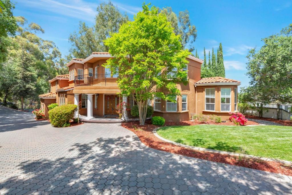 Welcome to this beautiful home in the charming Parker Ranch community. Situated on a generous 1.08-acre lot and spanning 2,797 square feet, this beautiful residence features 4 bedrooms, 3 full bathrooms and one half bathroom including a luxurious primary suite on the second floor complete with a retreat, a cozy fireplace, and a private balcony. Master bathroom has balcony facing yard. The spacious kitchen is designed for both functionality and style, offering granite countertops, a built-in oven range, dishwasher, refrigerator, and a walk-in pantry for added storage. Entertain in the formal dining room or enjoy casual meals in the separate breakfast nook area.. The home showcases a mix of carpet, slate, and other flooring, complemented by bay windows, high and vaulted ceilings, and abundant natural light. Exterior highlights include a 3-car garage and beautifully landscaped grounds, offering both curb appeal and serene outdoor space. Additional amenities include a security gate, separate storage shed area and a convenient indoor laundry area. Enjoy close proximity to walking trails, Saratoga Golf & Country Club, shopping, restaurants, and an easy commute with freeway access nearby. offering the perfect chance to add personal touches and TLC. Top Cupertino schools.
