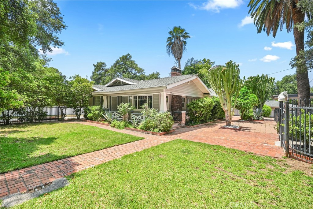 Set on an impressive 18,744 sq ft lot near JPL, this cherished Altadena treasure has been lovingly maintained by just two owners. Located in a serene, tree-lined neighborhood, the home gracefully survived recent fires and radiates historic charm and peaceful living. Zoned Equine District (LCR17500ED), this property offers rare flexibility, permitting horse keeping, expansive gardening, and the potential to add barns, garages, sheds, or an ADU (Accessory Dwelling Unit). It’s ideal for hobbyists, animal lovers, or multi-generational households seeking space and versatility. The park-like grounds feature three mature fruit trees, towering shade trees, and 100-year-old cacti. Classic brick paver walkways add texture and charm, while a lush front lawn enhances curb appeal. The lot is fully enclosed with wrought iron fencing, dual automatic gates, and a low-maintenance vinyl perimeter fence for added privacy and security. Inside, this single-story Craftsman showcases original character: wood-beam ceilings, built-in curio and china cabinets, a brick fireplace, and a sun-drenched sitting room. Hardwood floors flow throughout, accented by distressed reclaimed wood paneling for rustic warmth. The kitchen features granite countertops and updated appliances, offering function and style. Recent upgrades include a natural gas forced-air HVAC system, whole-house water filtration, and a California basement for extra storage. The primary bedroom boasts a walk-in closet, while the second bedroom includes a private entry, ideal for guests or a home office. For the eco-conscious, a fully paid and transferable Tesla solar system (installed 14 years ago) provides long-term energy savings. And according to the owner, the home was framed with cedar wood, known for its natural termite resistance—a valuable and rare detail.
This is a truly special opportunity to own a heritage-rich property with land, charm, and zoning flexibility in one of Altadena’s most desirable enclaves.